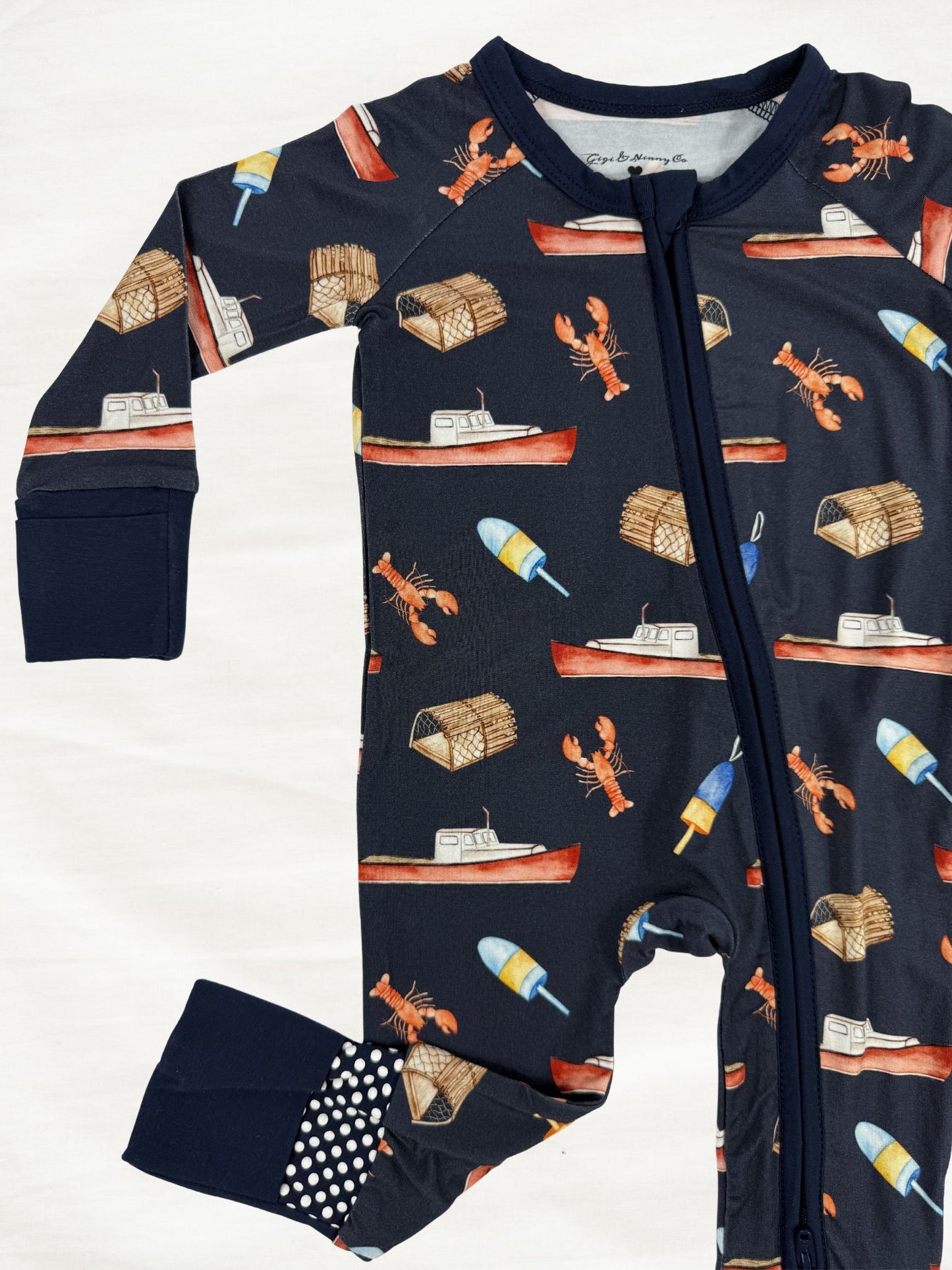 Navy baby onesie with lobster boat themed print