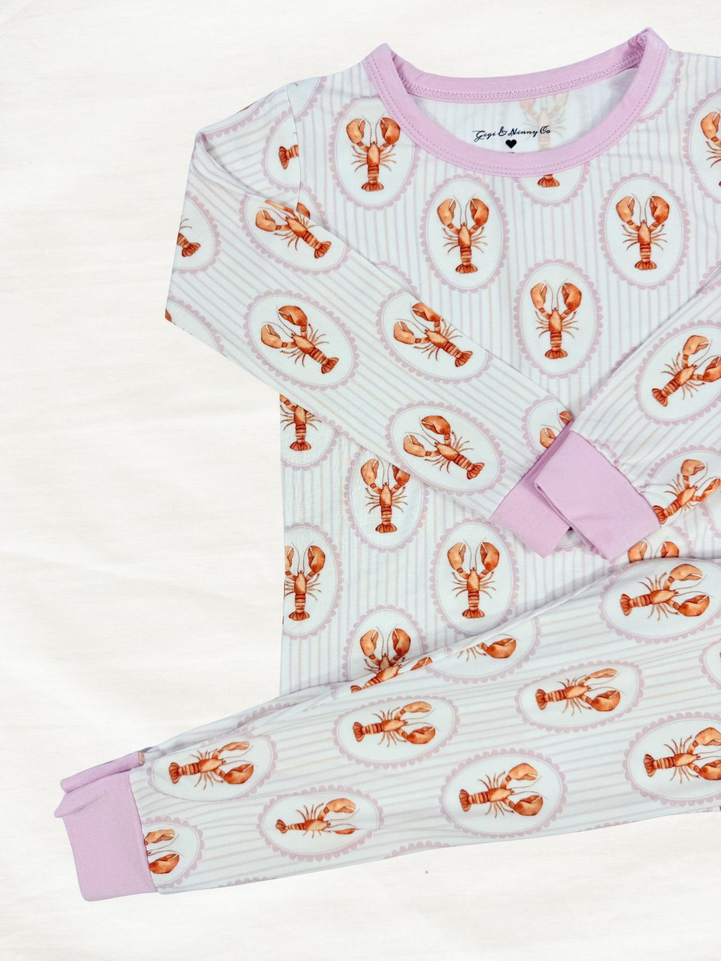 Children's pajama set with lobster pattern on a light background
